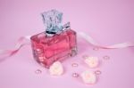 Pink Aromatic Perfume With Pink Pearls And Pink Textile Roses On Pink Background Stock Photo