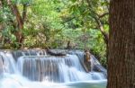 The Water Flowing Over Rocks And Trees Down A Waterfall At Huay Mae Khamin Waterfall National Park ,kanchana Buri In Thailand Stock Photo