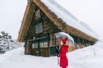 Young Woman In Shirakawa-go Village In Winter, Unesco World Heritage Sites, Japan Stock Photo