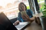 Young Asian Woman Working In Coffee Shop Stock Photo