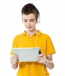 Boy Listening Music With Tablet Pc Stock Photo