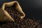 Coffee Beans In Sack On Black Background Stock Photo