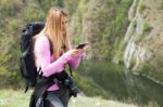 Woman At Mountain  On Mobile Phone Stock Photo