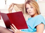 Woman Reading Book At Home Stock Photo