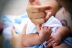 Hand Of A Baby Holding Mother's Finger Stock Photo