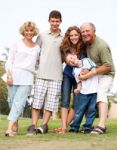 Happy Family Having Fun In The Park Stock Photo