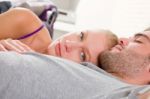 Couple Lying In Bed Stock Photo