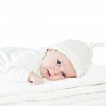 Blue Eyes Baby Boy On White Towels Stock Photo