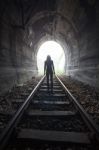 Man In A Tunnel Looking Towards The Light Stock Photo