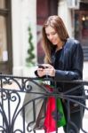 Female Shopper Texting Stock Photo