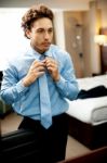 Businessman Adjusting Tie Stock Photo