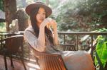 Woman Drinking Coffee In The Garden Outdoor In Sunlight Light En Stock Photo