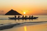 Group Of People In Boat At Sunset Stock Photo