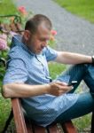 Man Looking At Smartphone Stock Photo