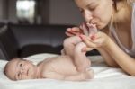 Kissing Baby Feet Stock Photo