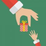 Santa Hand Giving A Gift Box To Kid Stock Photo