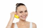 Smiling girl holding banana Stock Photo