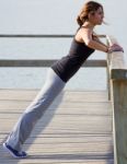 Young Woman Doing Push Ups Near The Sea Stock Photo