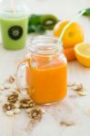 Orange Juice In Glass, Nuts And Fresh Fruits On Wooden Backgroun Stock Photo