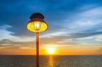 Lighting Of Warm Lamp And Lighting Of Sunset At Sea Stock Photo