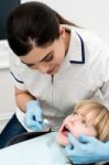 Cute Kid Getting Dental Checkup Stock Photo