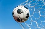 Soccer Football In Goal Net With The Sky Field Stock Photo