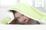 Baby Under Blanket Stock Photo