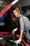 Young Female Trainee Fixing Car Engine In Garage Stock Photo