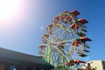 Ferris Wheel In Market With Sunlight And Clean Sky Background Stock Photo