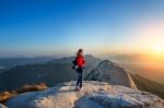 Woman Stands On The Peak Of Stone In Bukhansan National Park,seoul In South Korea And Watching To Sunrise. Beautiful Moment The Miracle Of Nature Stock Photo