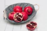 Fresh Pomegranate Fruits Isolated On A White Wooden Background Stock Photo