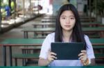 Portrait Of Thai Student Teen Beautiful Girl Using Her Tablet Stock Photo