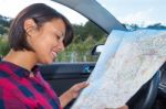 Woman Reading Road Map In Car Outdoors Stock Photo