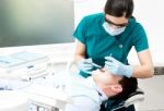 Dentist Cleaning Patient Teeth Stock Photo