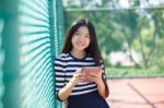 Asian Girl And Computer Tablet In Hand Standing With Toothy Smiling Face Use For People And Internet Connecting ,communication In Modern Digital Lifestyle Stock Photo