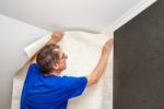 Elderly Worker Smoothing Wallpaper Stock Photo