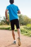 Man In Sportswear Running In A Park Stock Photo