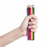 Colored Pencils In A Female Hand On A White Background  Stock Photo