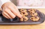 Woman Making Chocolate Chip Muffin Stock Photo