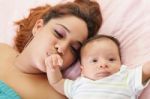 Hispanic Mother Kissing Her Baby Hand.  Focus On The Mother Stock Photo