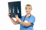 Lady Surgeon Holding Up X-ray Report Stock Photo