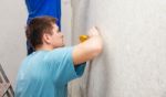 Young Worker Smoothing Wallpaper Stock Photo