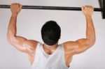 Young Man Lifting Dumbbells Stock Photo