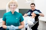 Male Dentist Treat Patient In Clinic Stock Photo