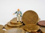 Miniature Businessman Stand On Euro Coins And Book Bank. Busines Stock Photo