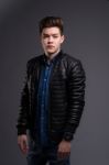 Casual Young Man In Black Leather Jacket And Denim Jeans Stock Photo