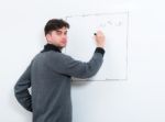 Teacher Writing On Whiteboard Stock Photo