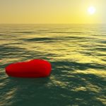 Red Heart Floating On Sea Stock Photo