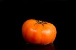 Red Tomato On A Black Background Stock Photo