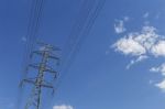 High Voltage Power Pole With Space On Clear Blue Sky Stock Photo